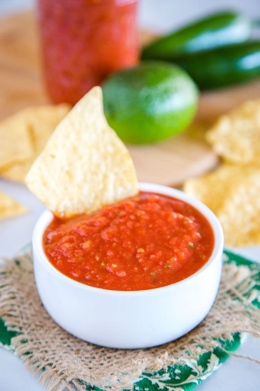 a white bowl filled with salsa and chips