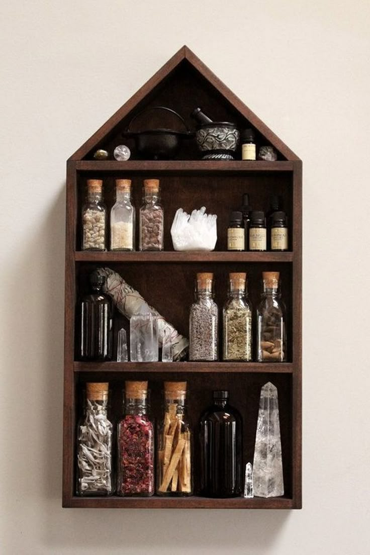 a wooden shelf filled with bottles and spices