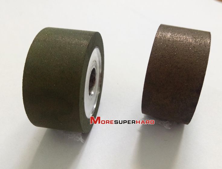 two rolls of brown tape sitting next to each other on top of a white table