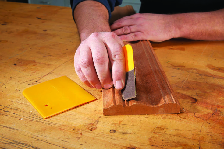 a person using a knife to cut cheese on a cutting board with a block of butter