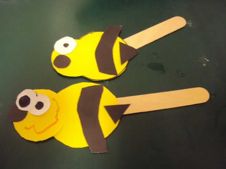 two yellow and black popsicle shaped like bees