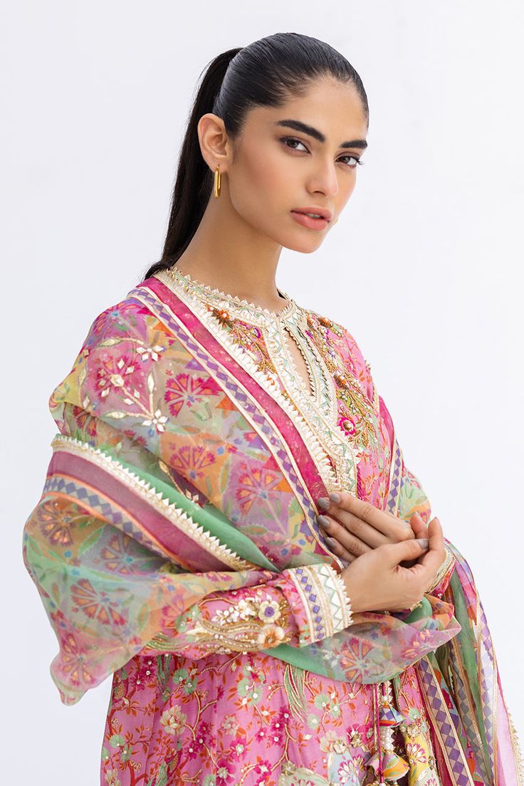 This short, aurora pink angarkha is the embodiment of a classy yet charming festive look. It is rendered with a thoughtful arrangement of zardoze and gota work on a floral-printed khaddi silk, featuring a chatapatti border. A multi-coloured dupatta with gota finishing and a printed shalwar add the final touches to this Pink Dola Silk Kurta With Cutdana, Designer Multicolor Kurta With Mirror Work, Multicolor Straight Kurta With Mirror Work, Pink Dupatta For Navratri, Multicolor Kurta With Sheer Dupatta For Diwali, Diwali Multicolor Kurta With Sheer Dupatta, Designer Chanderi Churidar With Gota Work, Chanderi Churidar With Gota Work, Chanderi Churidar With Gota Work For Transitional Season