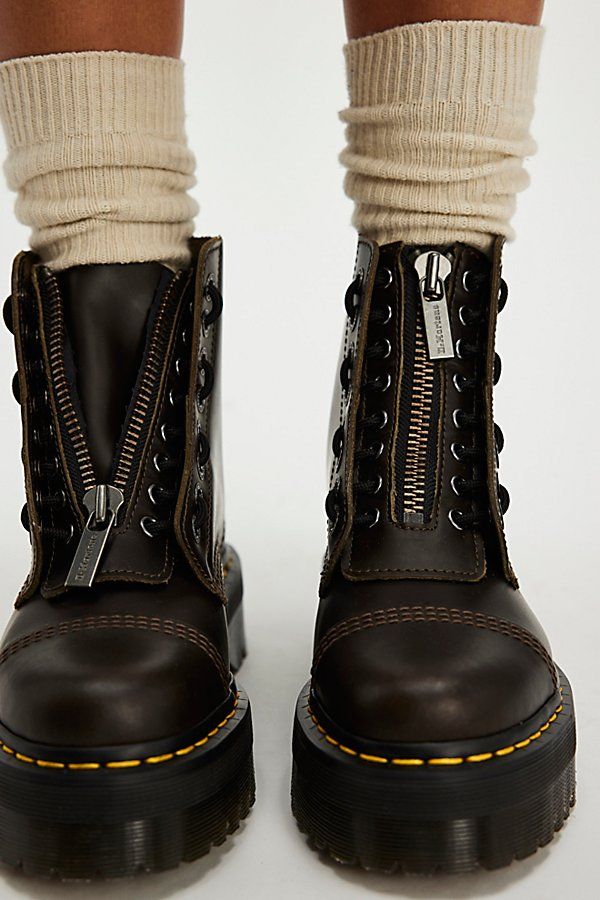 **Fit Note:** If in between whole sizes, we recommend sizing down. Rugged, military-inspired boots from Dr. Martens featuring a chunky, 8-eye design with a zip-up tongue that stays true to the brand’s iconic DNA with yellow stitching and grooved edges. * Lace-up and zip-up design * Air-cushioned sole * Slip-resistant | Dr. Martens Sinclair Zip Front Boots at Free People in Tan, Size: US 7 Adrian Doc Martens, Zip Up Doc Martens, Custom Doc Martens, Sinclair Dr Martens, Taupe Boots Outfit, Doc Martens Sinclair, Doc Martens Shoes, Dr Martens Sinclair, Doctor Martens