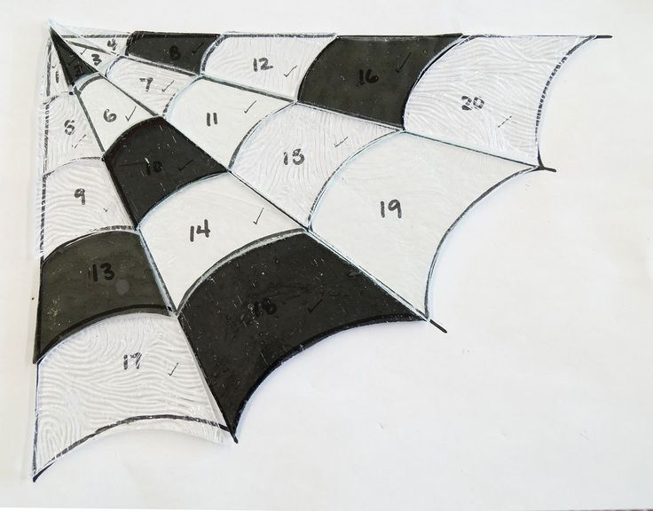 an arrangement of black and white umbrellas with numbers on the sides, arranged in rows