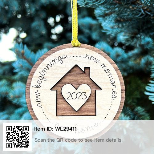 a wooden ornament hanging from a christmas tree with a house and heart on it