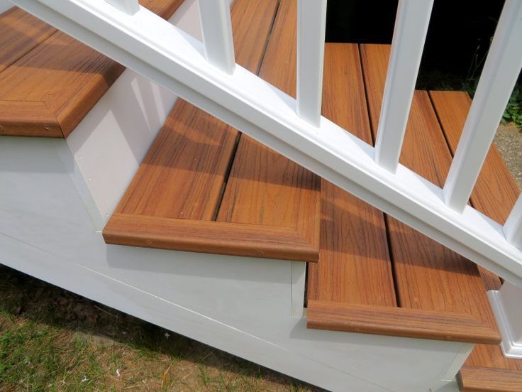 wooden steps with white railing and handrails