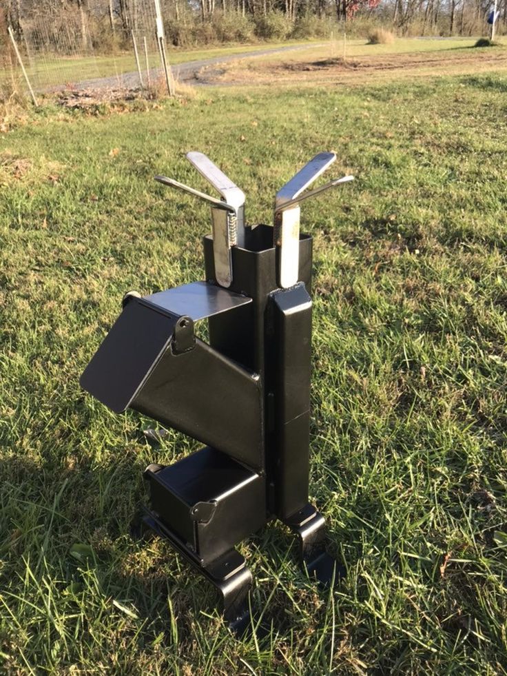 a metal sculpture sitting in the middle of a field