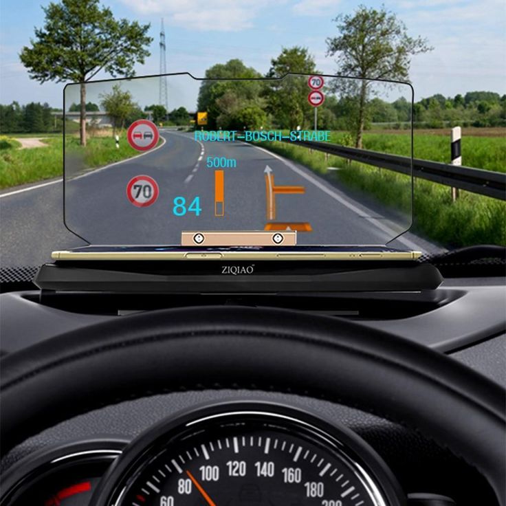 the dashboard view of a car driving down a country road