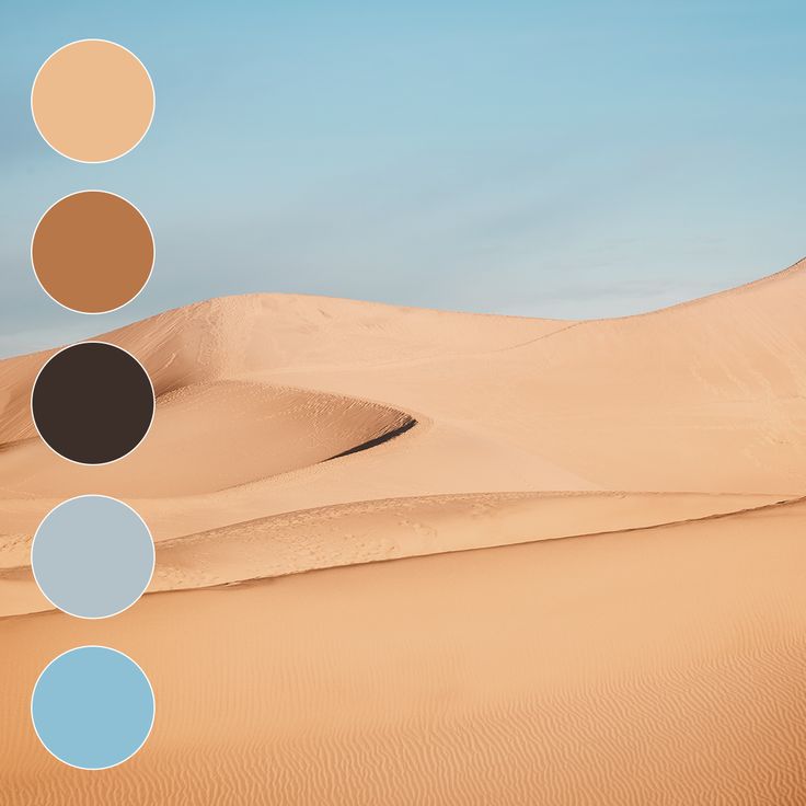 the desert is filled with sand dunes and blue circles on each side, as well as four different colors