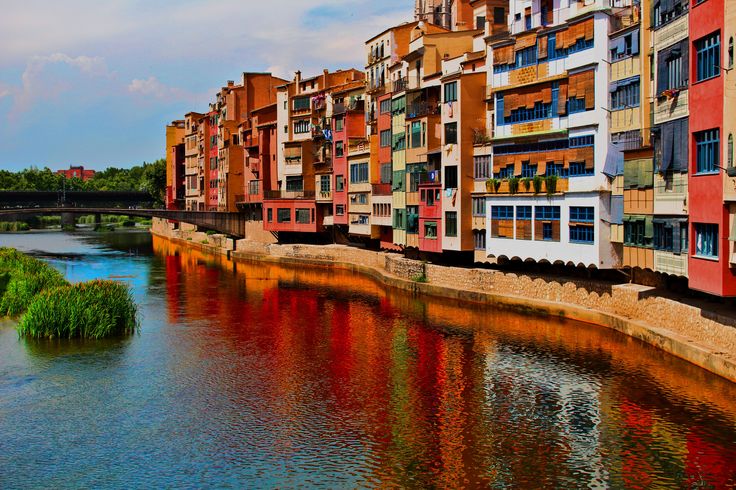 a river running through a city next to tall buildings