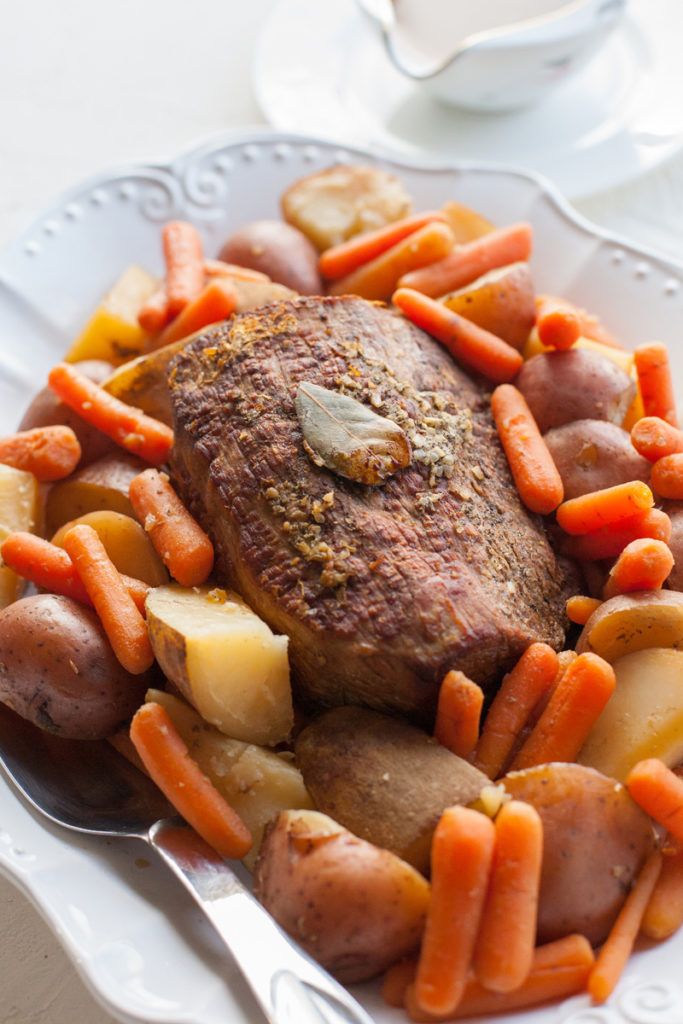 a white plate topped with meat and veggies