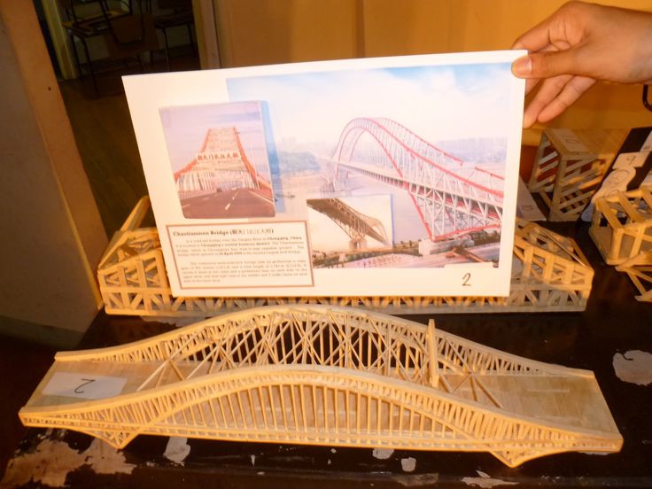 a model of a bridge being held up by someone's hand over the top of it