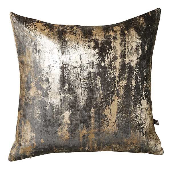 a silver and gold pillow with black spots on the front, sitting on a white background