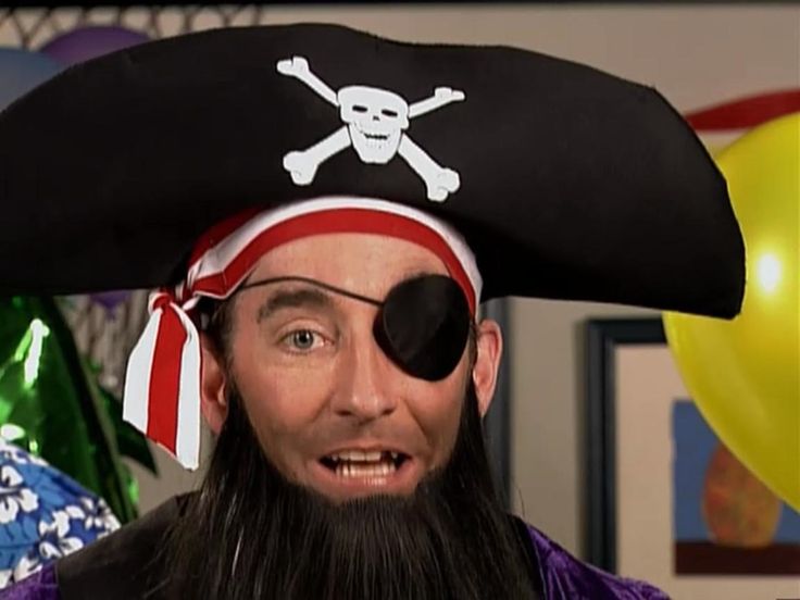 a man with a pirate hat and eye patch is making an odd face for the camera