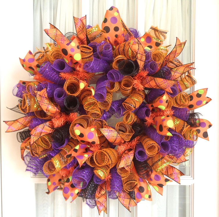 a wreath with orange and purple decorations on it