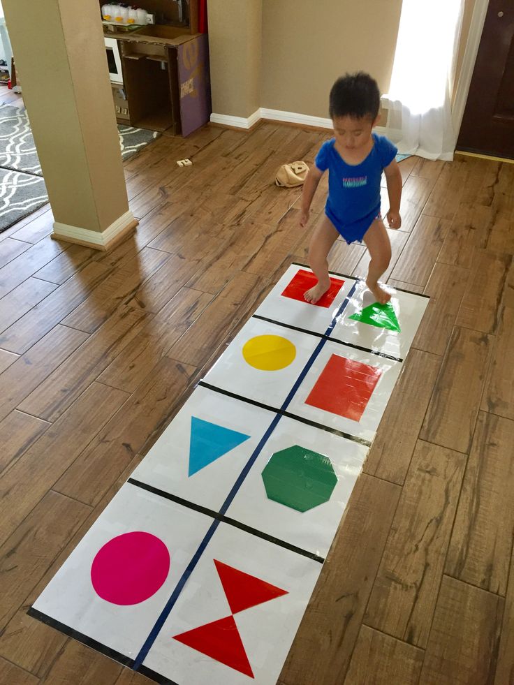 a young boy is playing with an interactive game on the floor