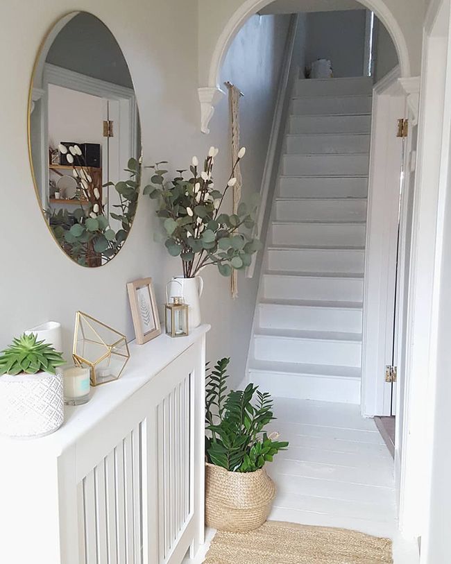 there is a plant on the shelf next to the stairs