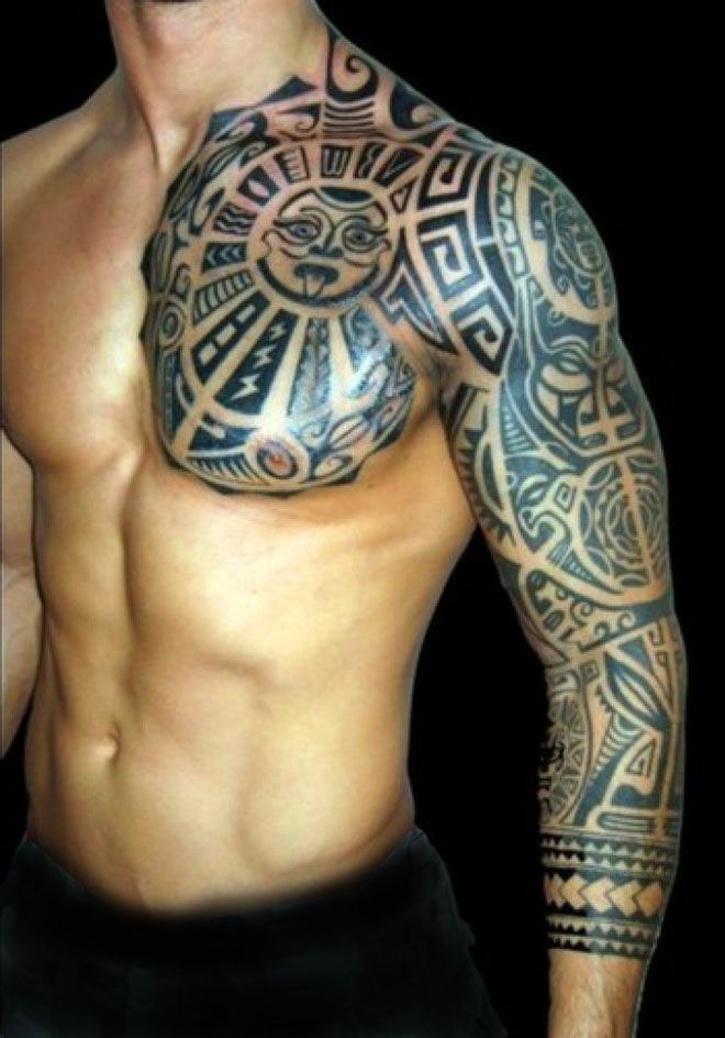 a man with tattoos on his arm and chest