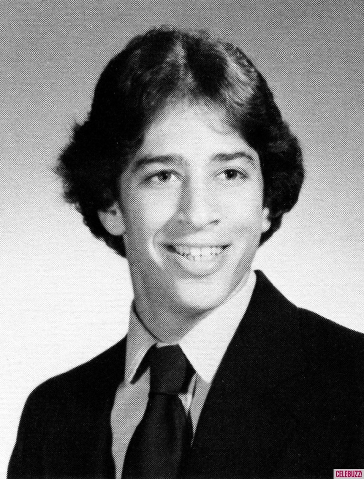 a young man in a suit and tie smiling