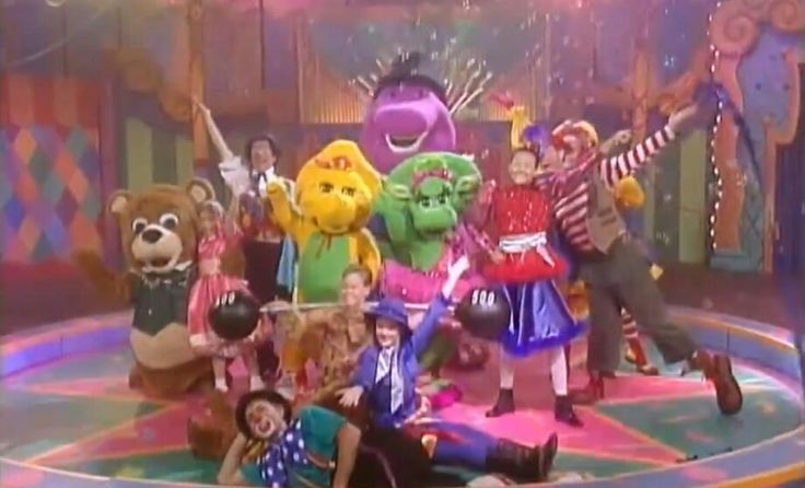 the children are posing for a photo on stage with their stuffed animals and clowns