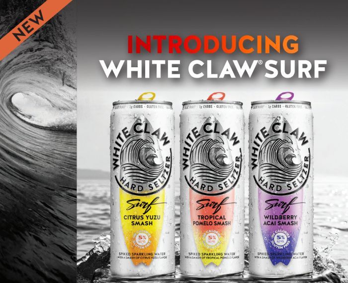 three cans of white claw surf are in the water with an orange and black background