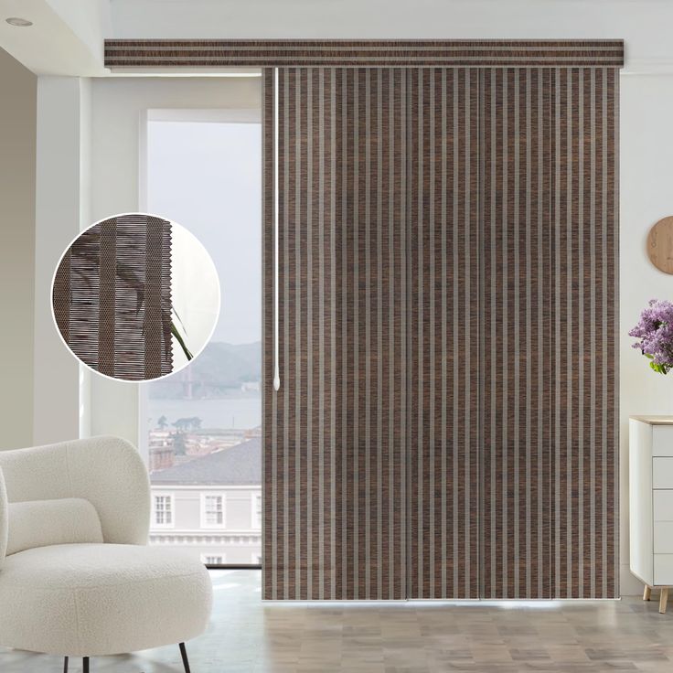 a white chair sitting in front of a sliding glass door with vertical blinds on it