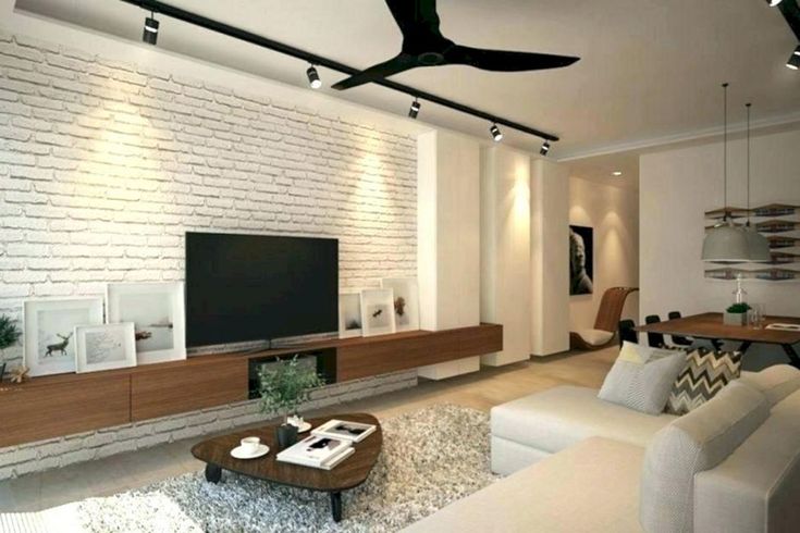 a living room filled with furniture and a flat screen tv mounted on a wall next to a wooden coffee table