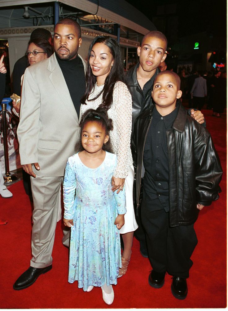 a group of people standing on top of a red carpet