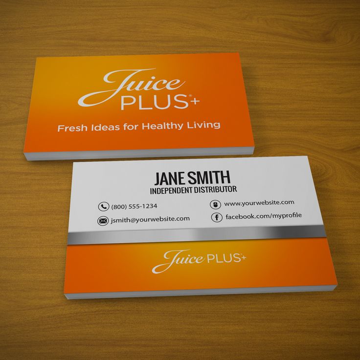 two business cards sitting on top of a wooden table next to an orange and silver logo