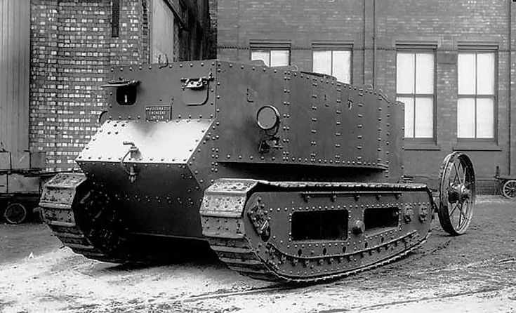 an old tank is parked in front of a brick building