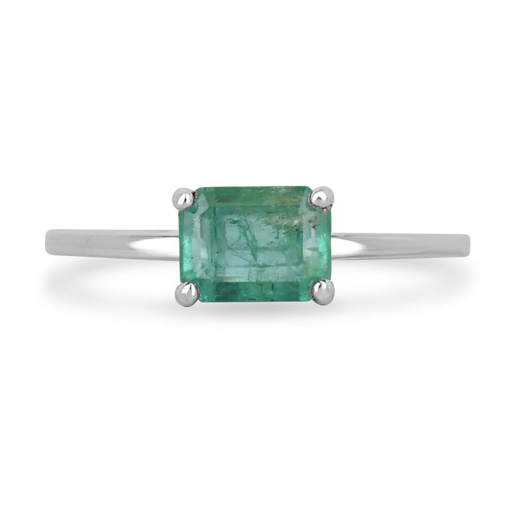 an emerald ring on a white background