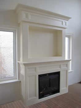 an empty living room with a fire place