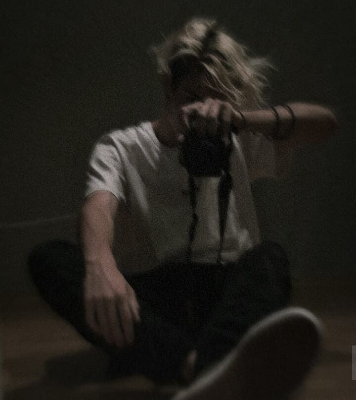 a person sitting on the floor with a camera