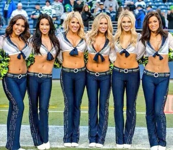 the cheerleaders are posing for a photo on the field at a football game