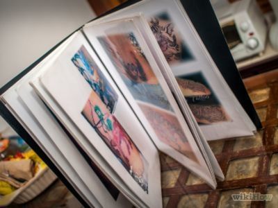 an open book sitting on top of a table next to a pile of books with pictures