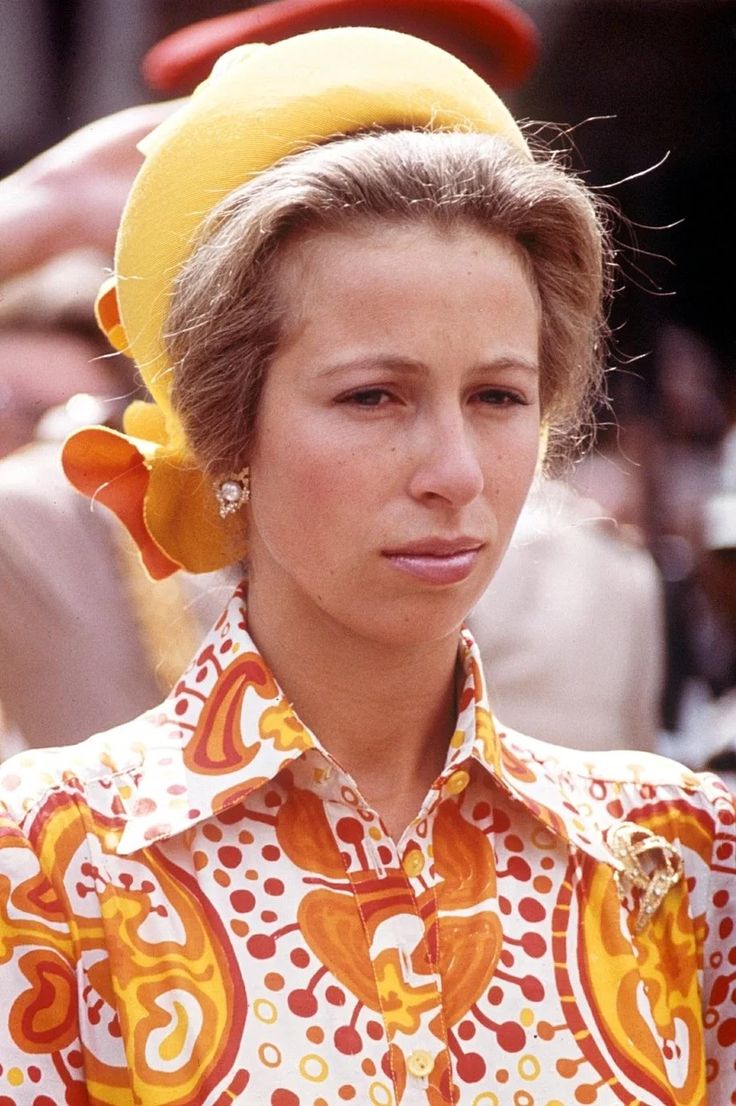 a woman wearing a yellow hat and dress shirt