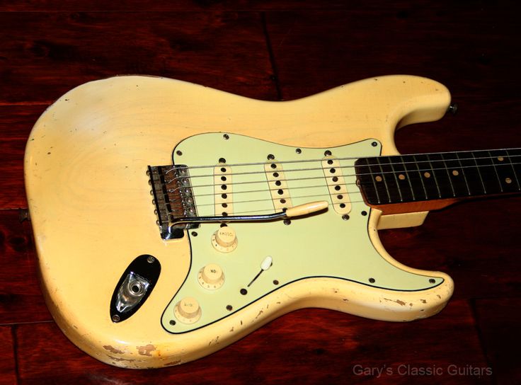 an electric guitar sitting on top of a wooden floor