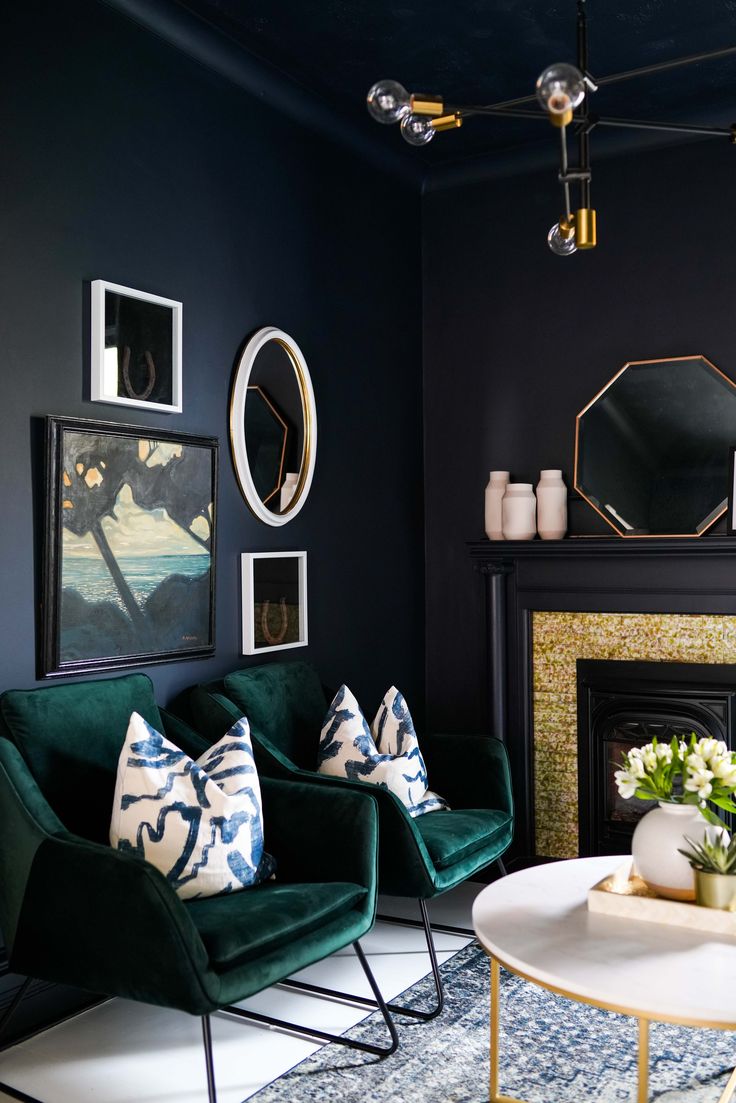 a living room filled with furniture and a fire place next to a painting on the wall