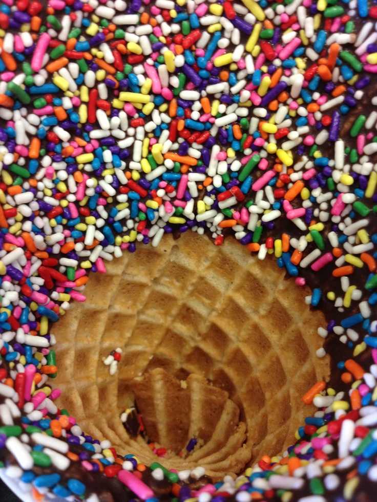 sprinkles on top of a donut with a hole in the middle