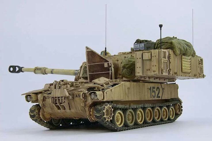 a toy army tank sitting on top of a white table