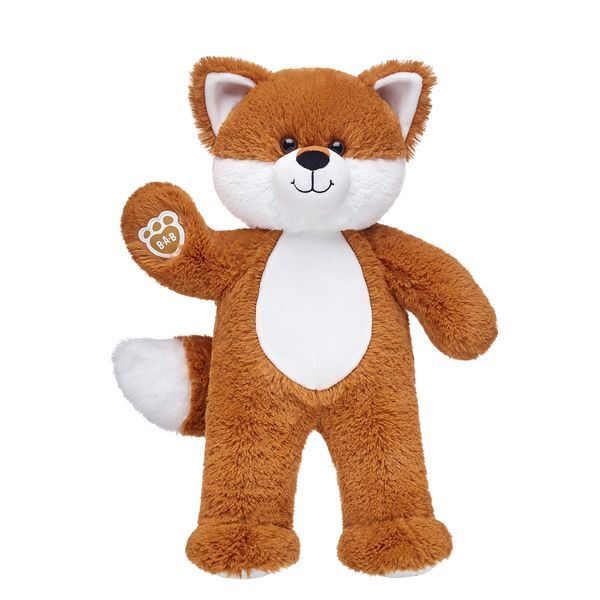 a brown and white stuffed animal with one paw raised in the shape of a fox