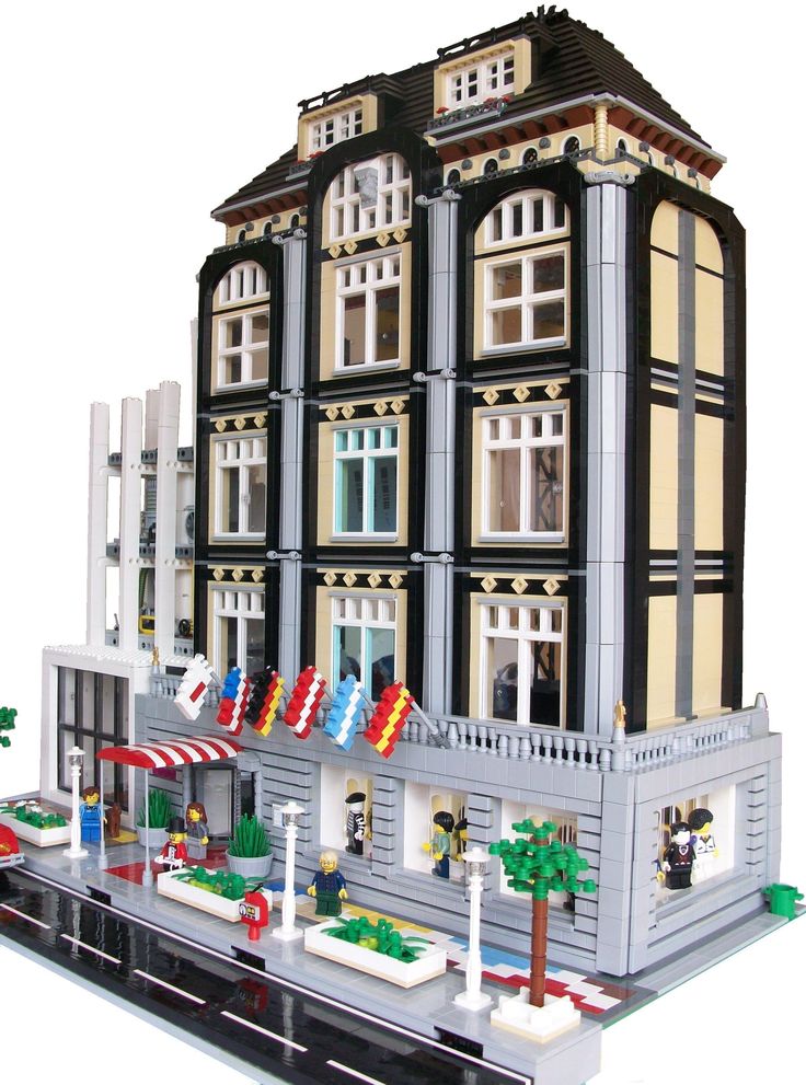 a lego model of a building with many windows and flags on the front of it