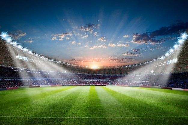 an empty soccer stadium with bright lights