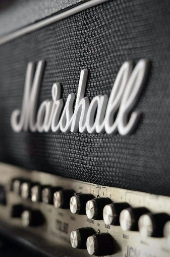 the marshall logo is on top of an old amp guitar amplifier's head and knobs