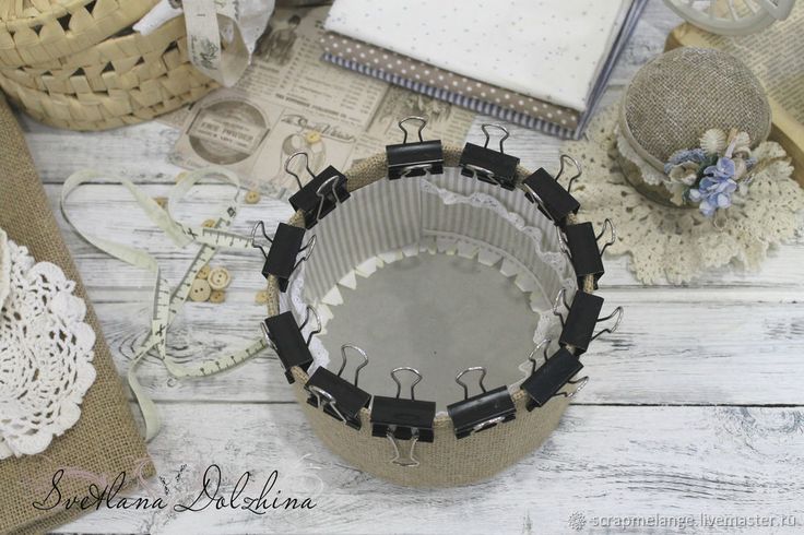 a table topped with lots of crafting supplies and paper doily on top of a white wooden floor