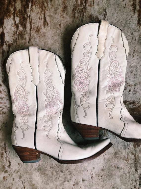 For our statement makers :: we couldn’t love these white and pink embroidered western boots any more than we already do! Perfectly worn-in with loads of character, we’re grabbing for these every day of the week. If you appreciate broken-in, distressed leather #bohostyle #leatherboots #cowboyboots #vintage #bohobag #western #festival #coachella Bohemian Shoes, Western Festival, Western Handbags, Boho Boots, Western Vintage, Embroidered Boots, Genuine Leather Boots, Boho Purses, Festival Bag