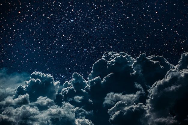 the night sky is filled with clouds and stars