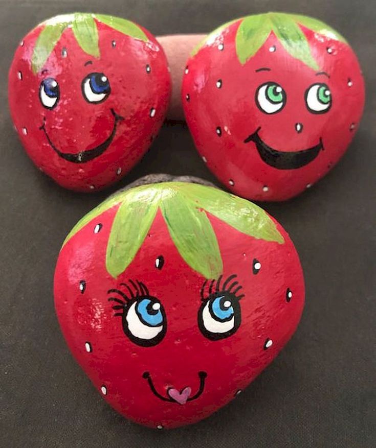 three painted rocks with faces on them