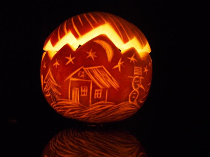 a pumpkin carved to look like a house