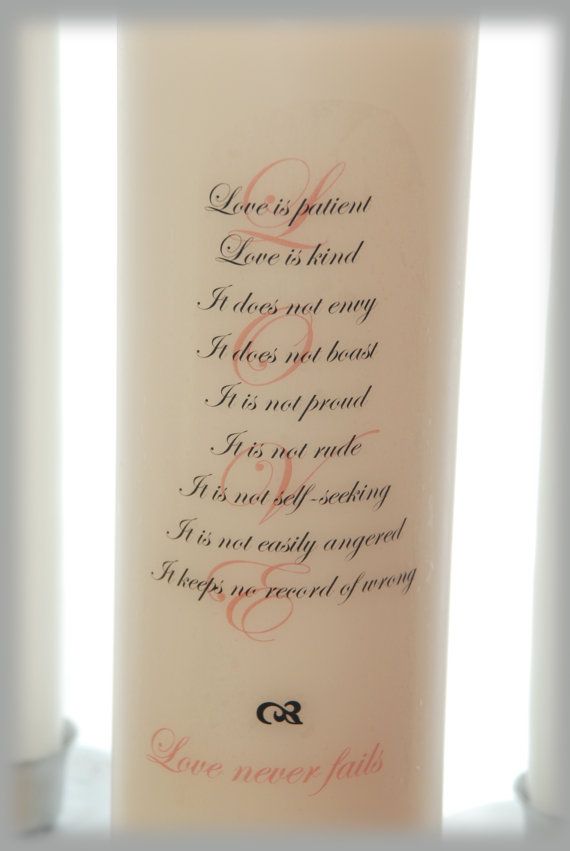 a candle with the words love is patient written in cursive writing on it